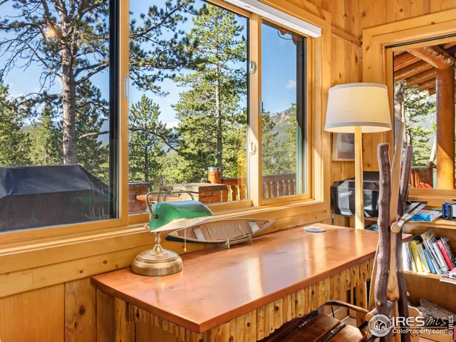 a view of a balcony with floor to ceiling windows with wooden floor