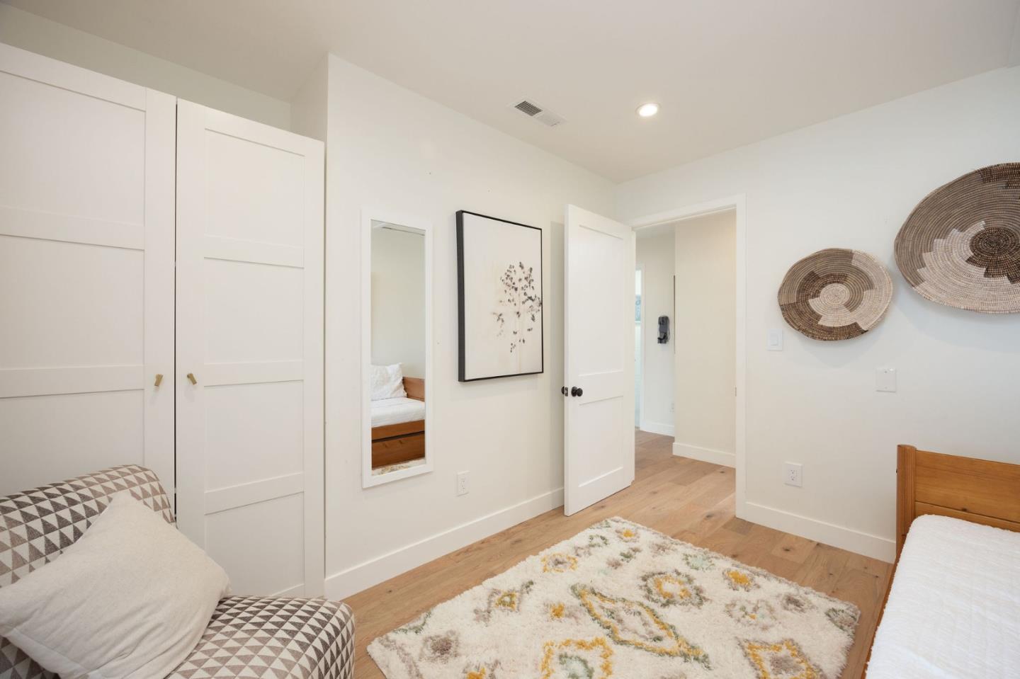 1460 Flores Drive Pacifica, CA 94044 - Photo 32 of 69 a bedroom with a bed and cabinets