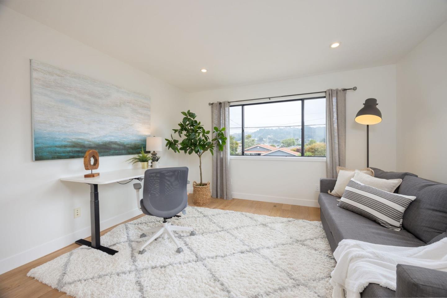 1460 Flores Drive Pacifica, CA 94044 - Photo 38 of 69 a living room with furniture and a potted plant