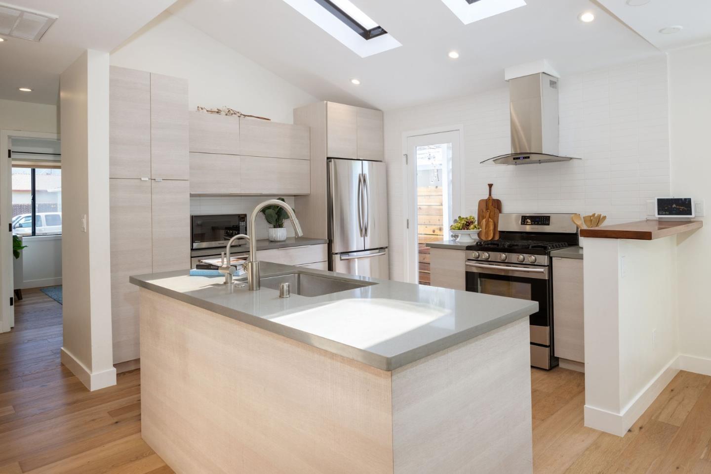 1460 Flores Drive Pacifica, CA 94044 - Photo 6 of 69 a kitchen with stainless steel appliances a sink stove and refrigerator