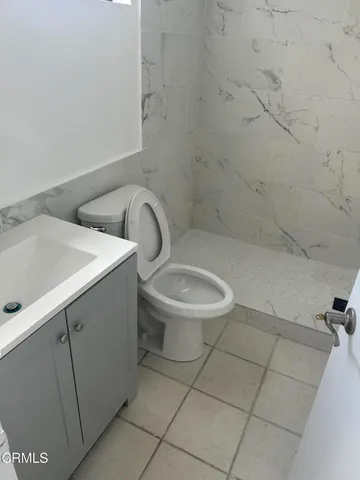 a white toilet sitting next to a bathroom sink
