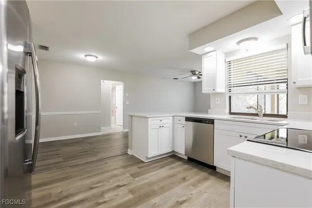 a kitchen with a stove a refrigerator and a window