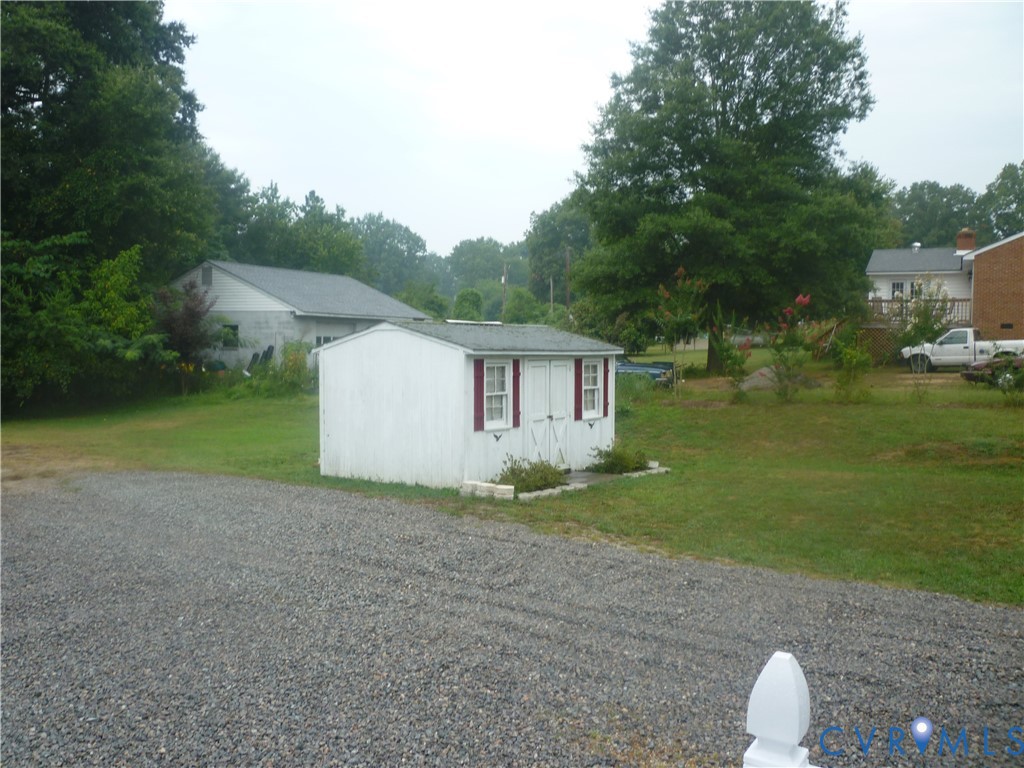1645 Manakin Road Manakin-Sabot, VA 23103 - Photo 6 of 6 Gravel driveway leading to a white storage shed wi