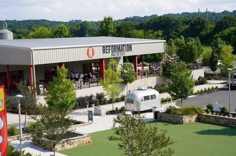 172 Railroad Street Canton, GA 30114 - Photo 8 of 8 a view of a patio with table and chairs plants and large trees