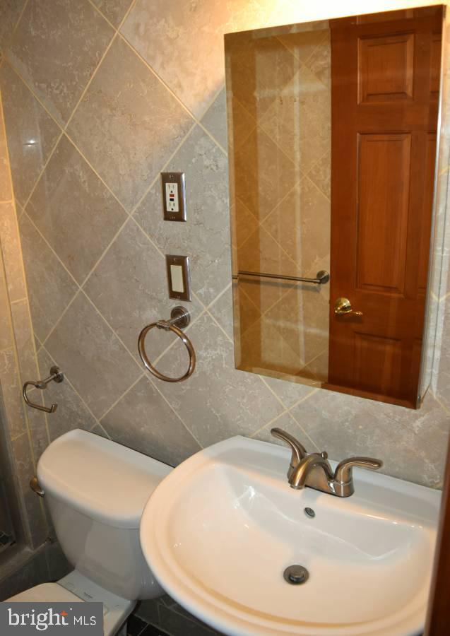 39 Bryant Street Northwest Washington, DC 20001 - Photo 4 of 17 a bathroom with a sink a toilet and shower