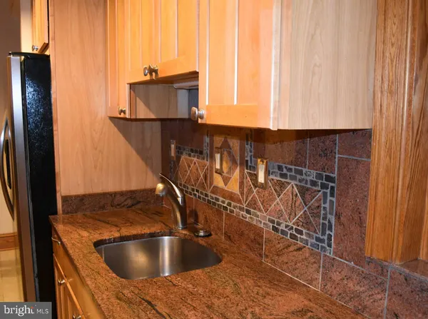 a kitchen with a sink and a refrigerator