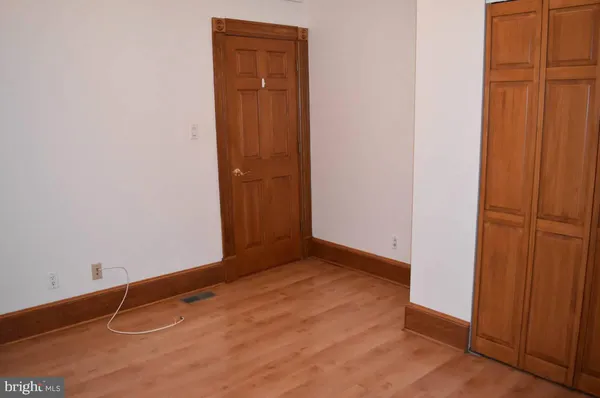 an empty room with wooden floor