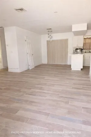 a view of a kitchen with wooden cabinet and floors