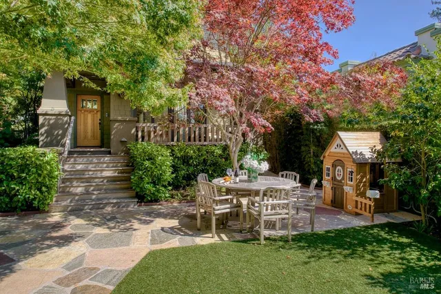 a view of a house with a yard and sitting area