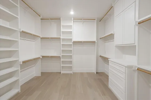 a view of walk in closet with empty racks