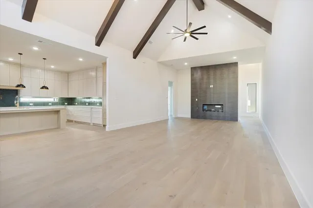 a view of a kitchen with a sink and a refrigerator