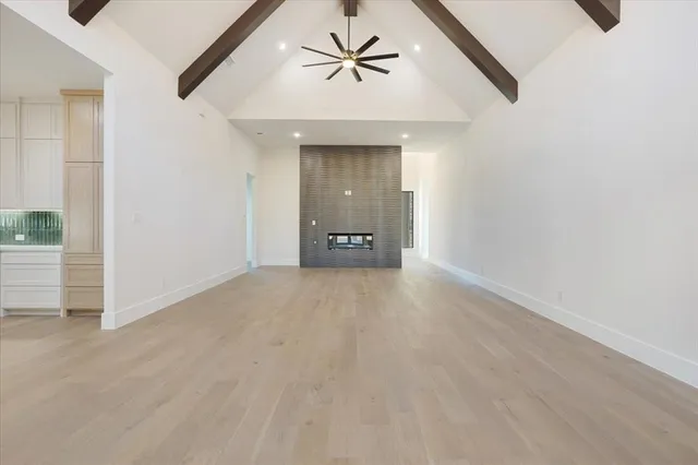 an empty room with a ceiling fan and a window
