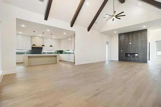a view of a kitchen with a sink and a refrigerator