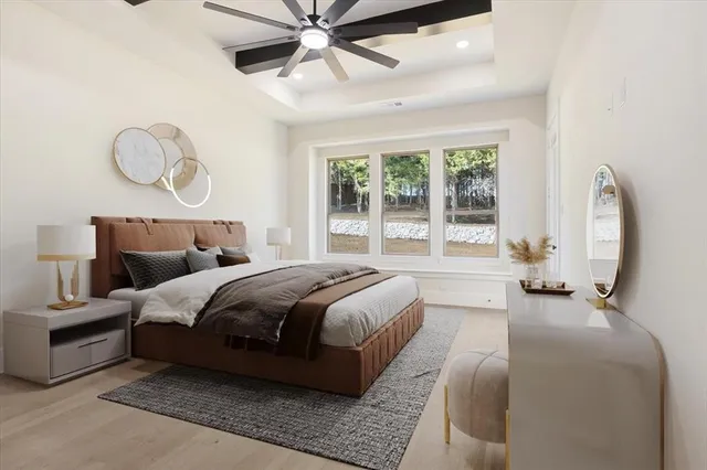 a bedroom with a large bed and windows