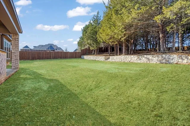 a view of a yard with a house in the background