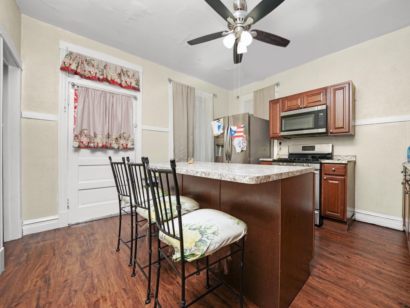 2131 North Springfield Avenue Chicago, IL 60647 - Photo 13 of 30 a kitchen with a table chairs refrigerator and microwave