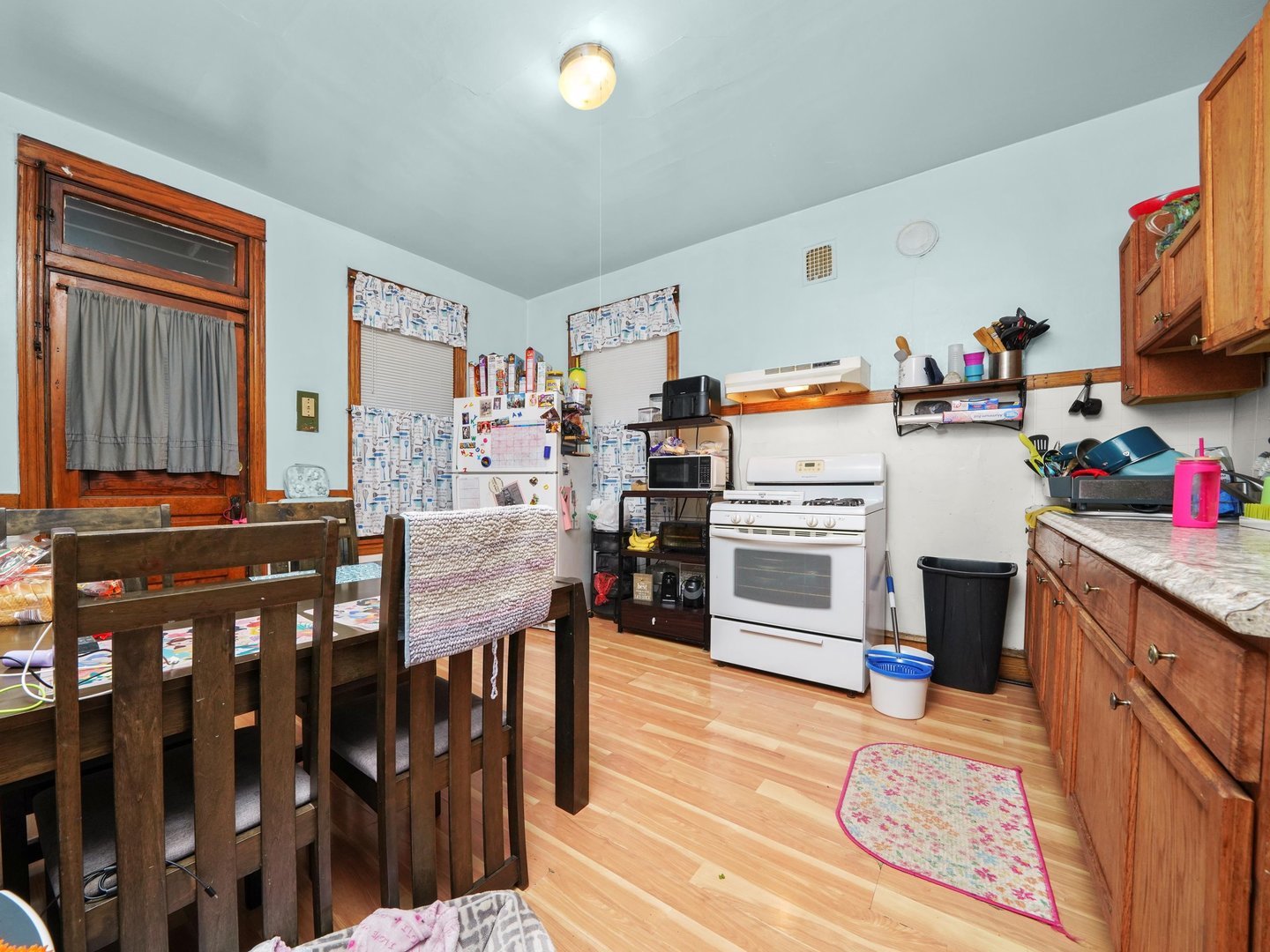 2131 North Springfield Avenue Chicago, IL 60647 - Photo 23 of 30 a kitchen with stainless steel appliances wooden floor and refrigerator