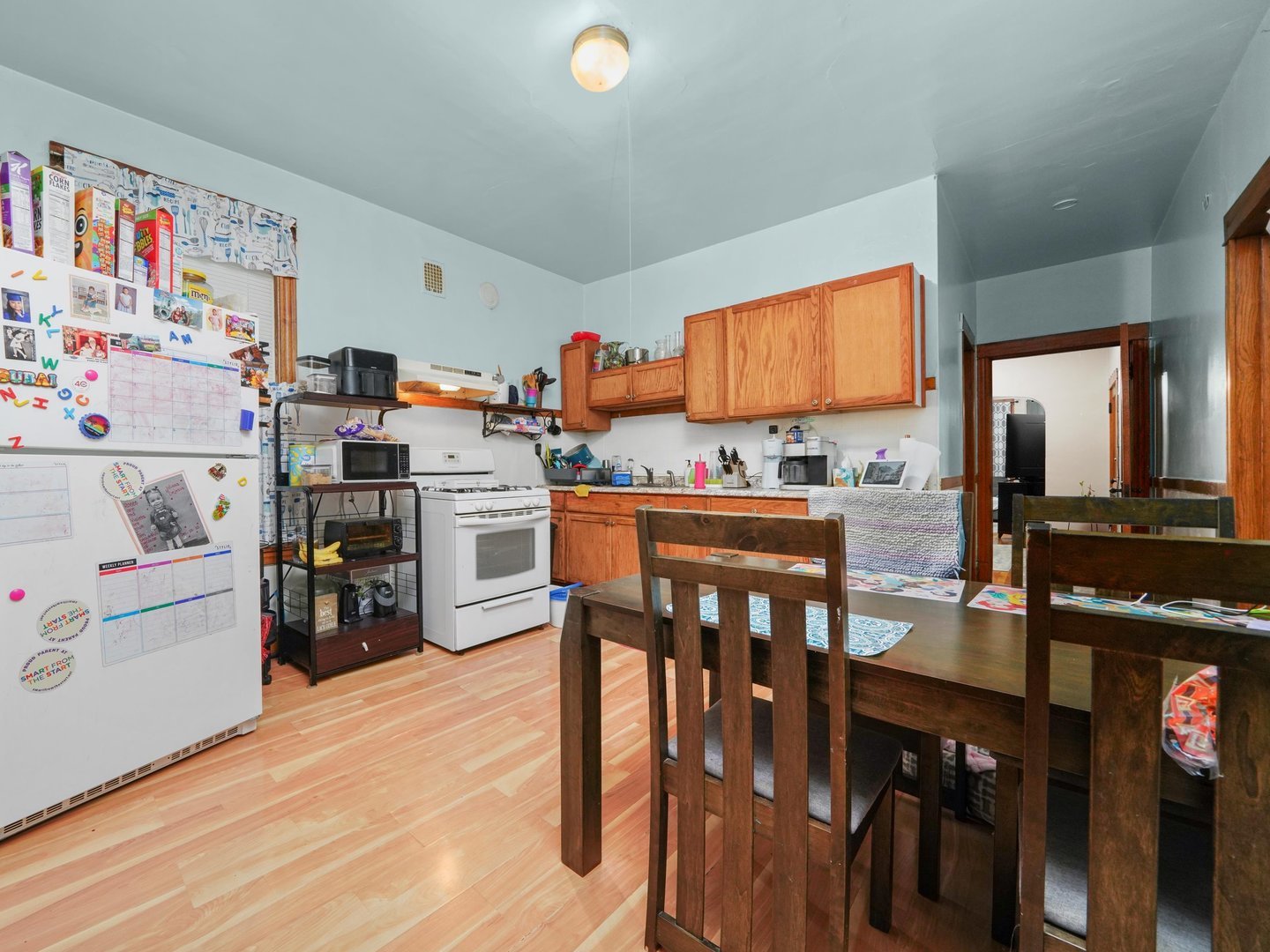 2131 North Springfield Avenue Chicago, IL 60647 - Photo 25 of 30 a kitchen with a table chairs and a refrigerator