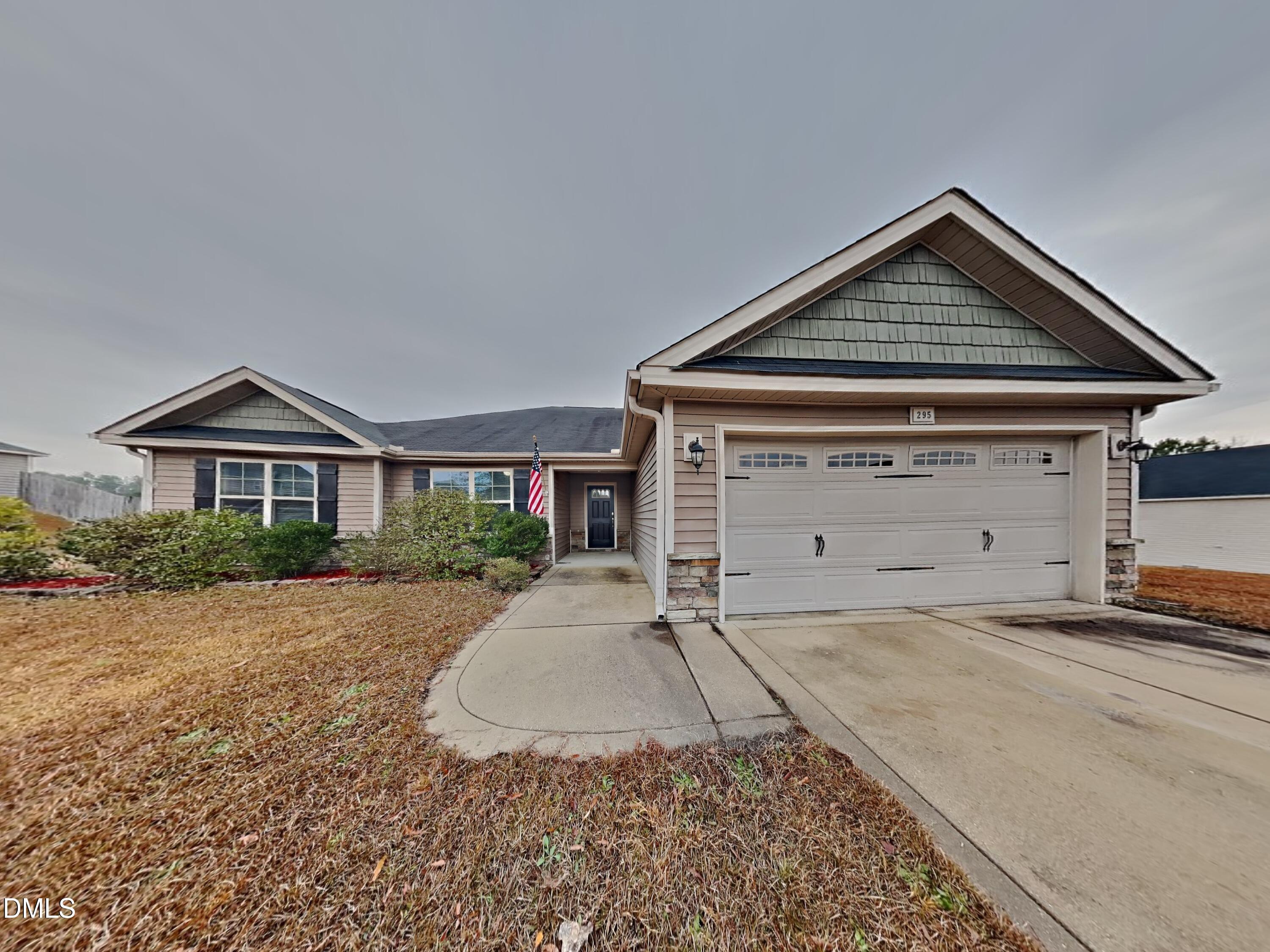 295 New Castle Lane Spring Lake, NC 28390 - Photo 1 of 17 a front view of a house with a yard and garage