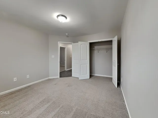 a view of an empty room and a window