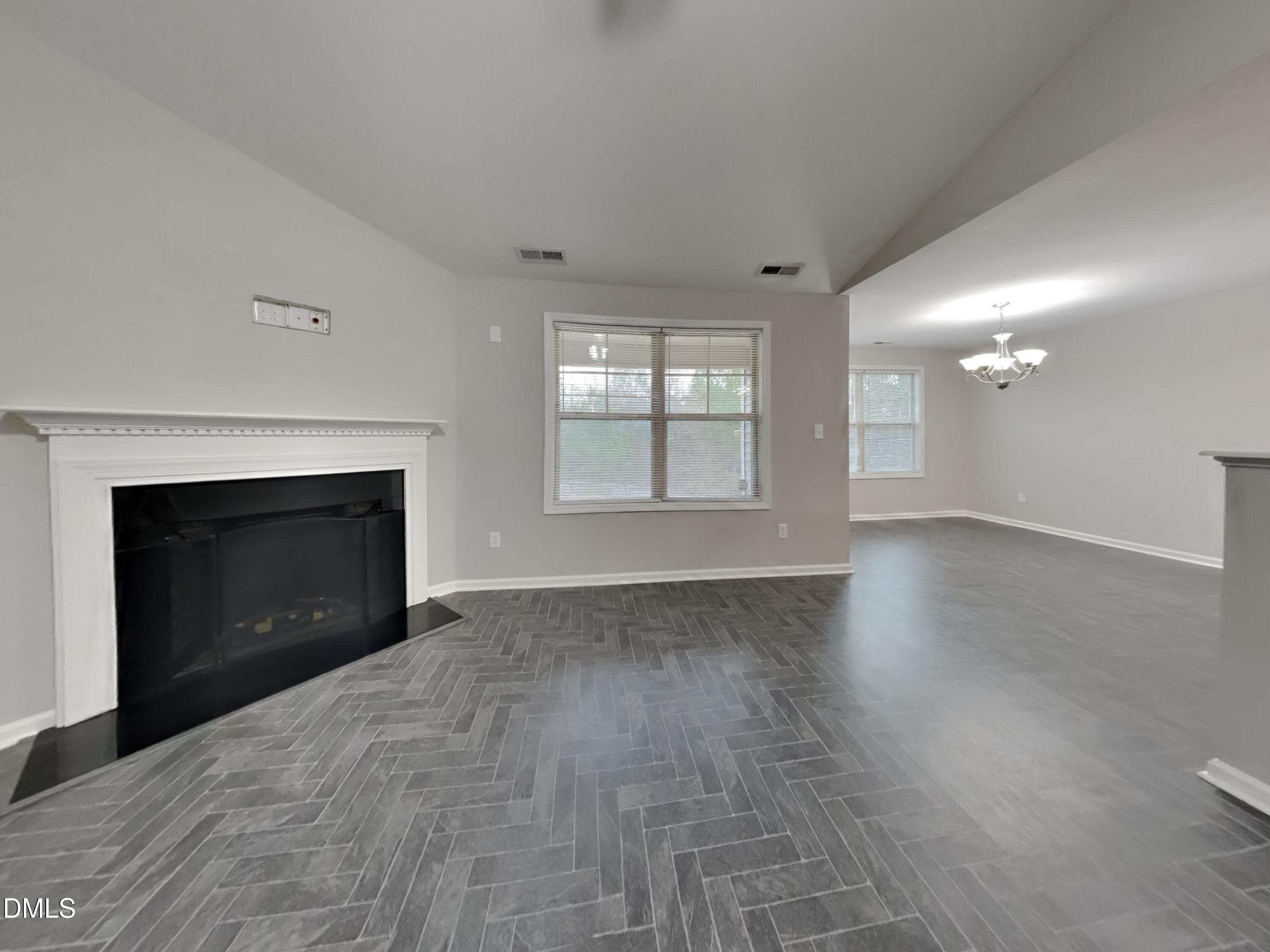 295 New Castle Lane Spring Lake, NC 28390 - Photo 3 of 17 an empty room with windows and fireplace