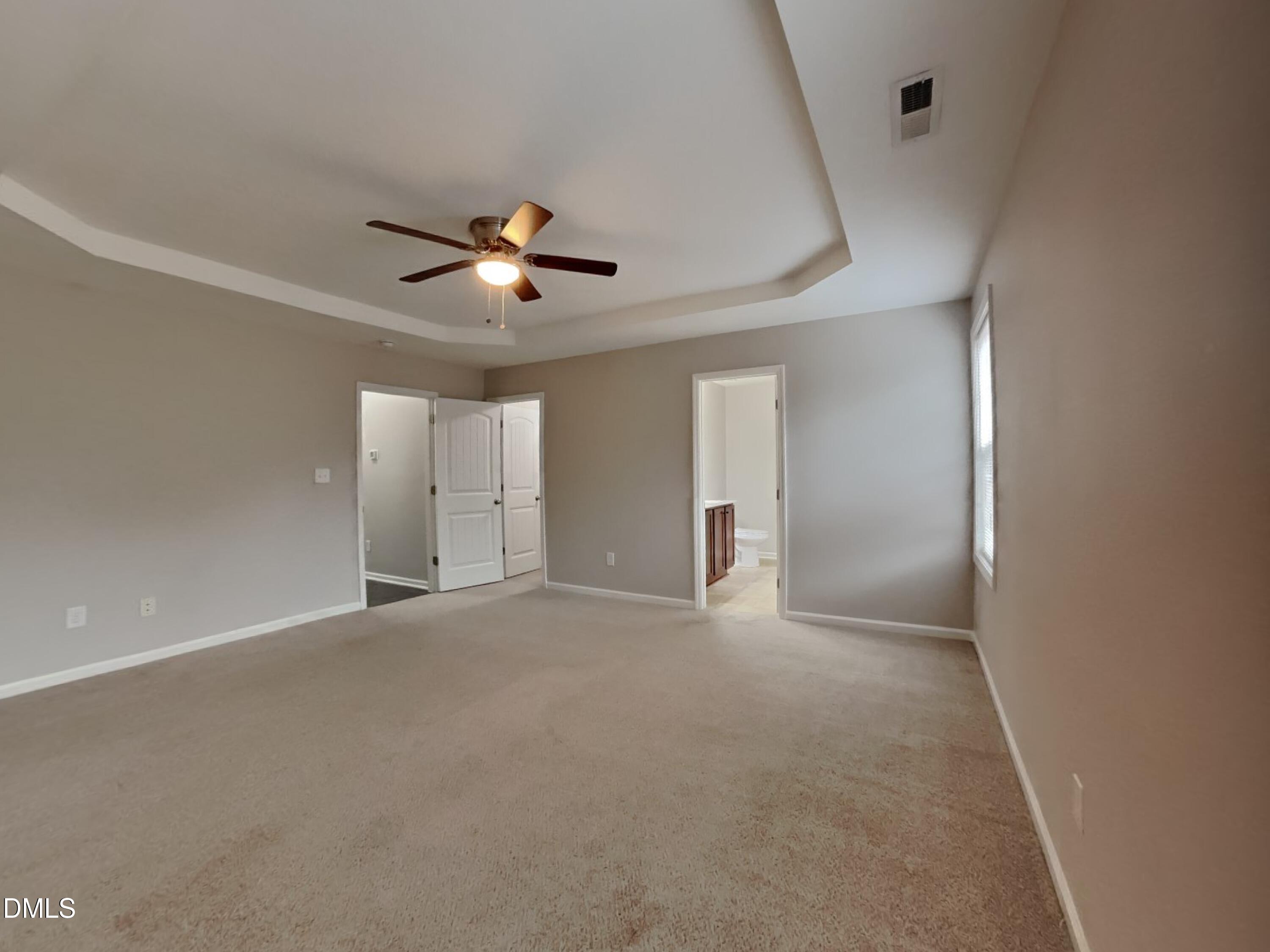 295 New Castle Lane Spring Lake, NC 28390 - Photo 7 of 17 a view of an empty room with a ceiling fan