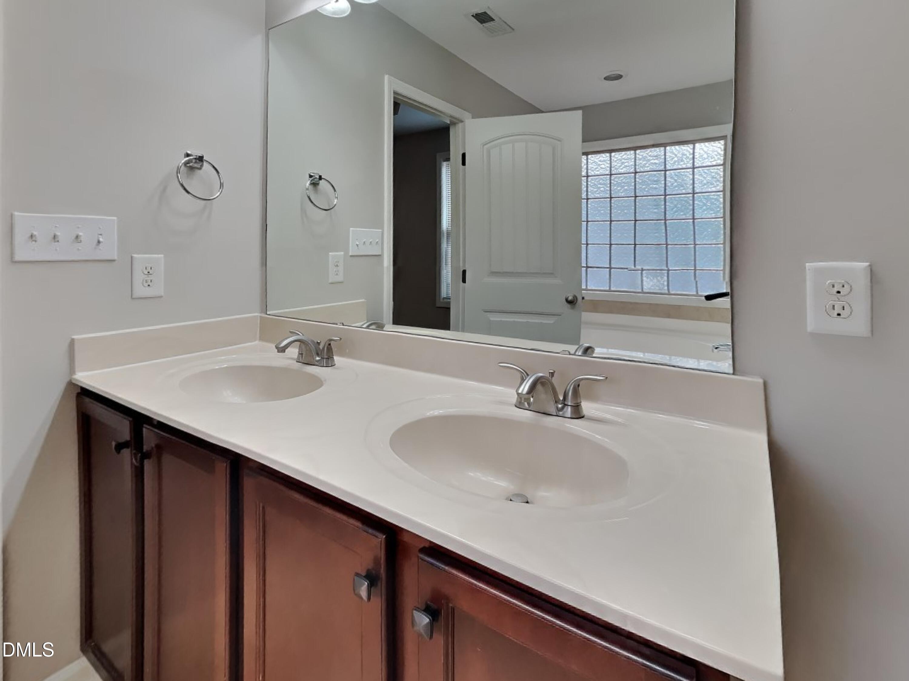 295 New Castle Lane Spring Lake, NC 28390 - Photo 8 of 17 a bathroom with a sink and a large mirror