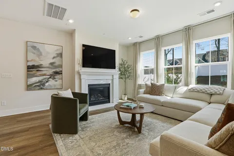 a living room with furniture dining table and a fireplace