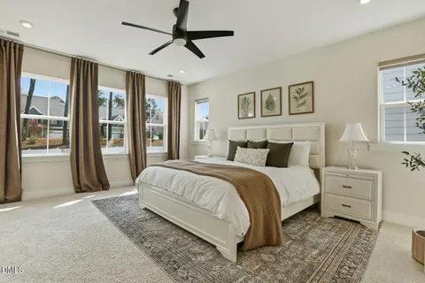 a spacious bedroom with a bed and a dresser