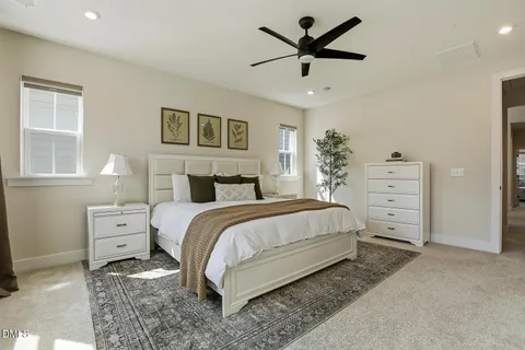 a spacious bathroom with a granite countertop sink a toilet a mirror and shower
