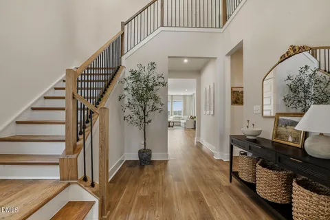 a view of entryway and hall with wooden floor
