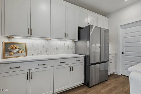 a kitchen with stainless steel appliances white cabinets and a stove top oven