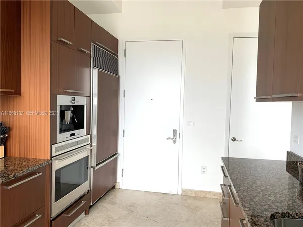 a kitchen with stainless steel appliances granite countertop a refrigerator and a stove