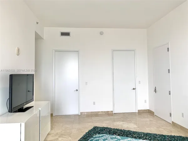 a view of a livingroom with wooden floor and a sink