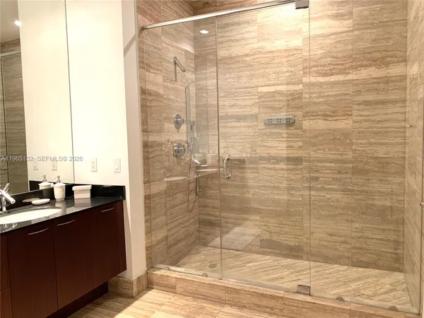 a bathroom with a shower and a sink