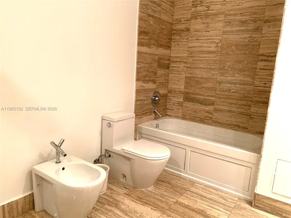 a bathroom with a bathtub and sink