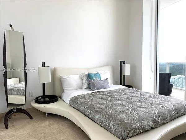 a bedroom with a bed and dresser