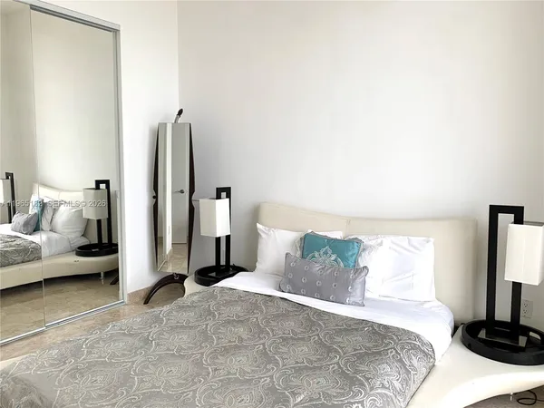 a bedroom with a bed and a couch