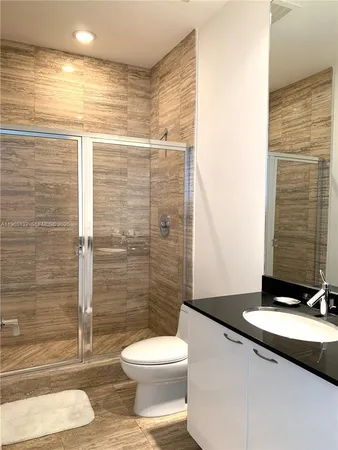 a bathroom with a toilet a sink and shower