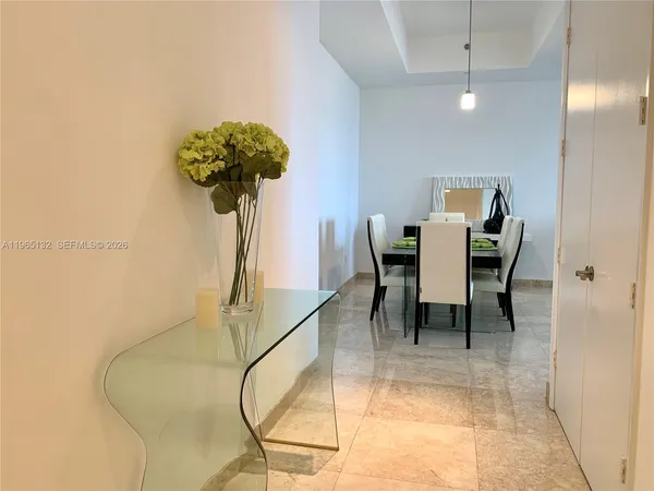 a view of a dining room with furniture and a chandelier
