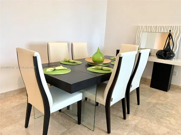 a dining room with furniture and a kitchen view