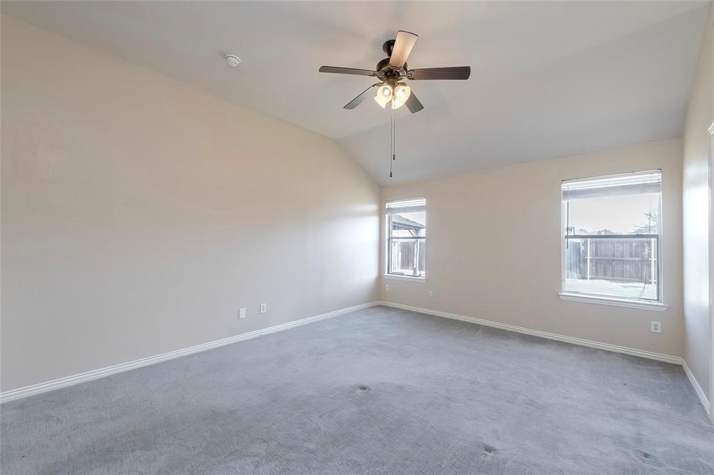2716 Dawn Spring Drive Little Elm, TX 75068 - Photo 13 of 23 an empty room with a chandelier fan and windows