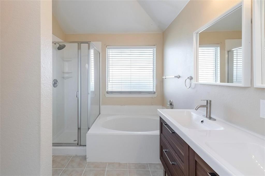 2716 Dawn Spring Drive Little Elm, TX 75068 - Photo 15 of 23 a bathroom with a tub sink and mirror
