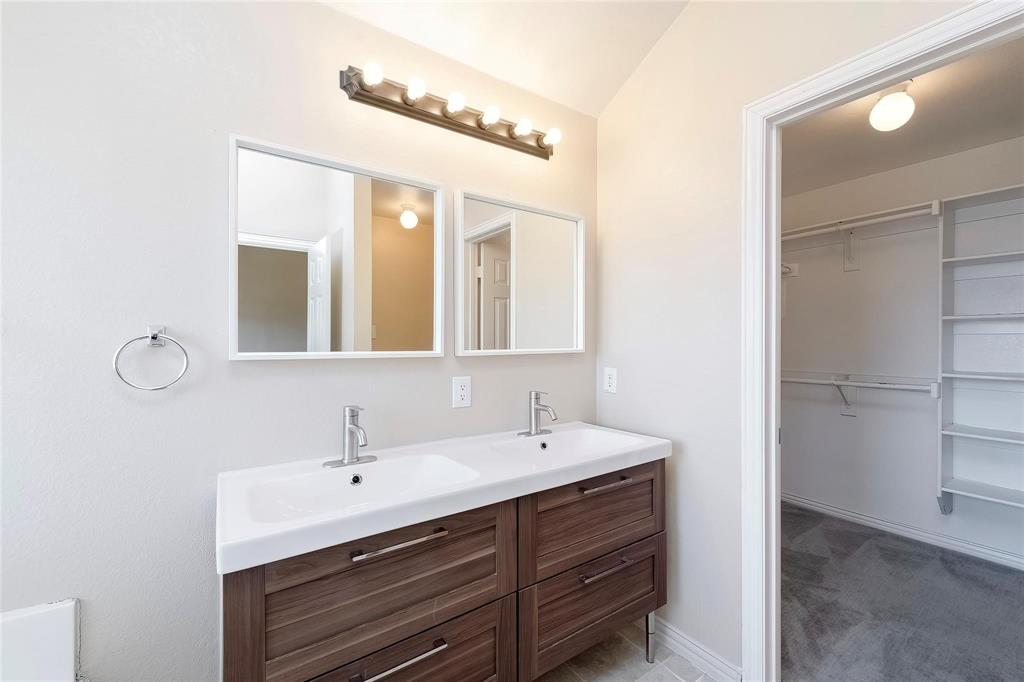 2716 Dawn Spring Drive Little Elm, TX 75068 - Photo 16 of 23 a bathroom with a sink vanity and a mirror