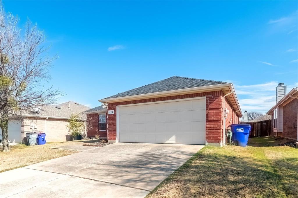 2716 Dawn Spring Drive Little Elm, TX 75068 - Photo 2 of 23 a front view of a house with a yard and garage