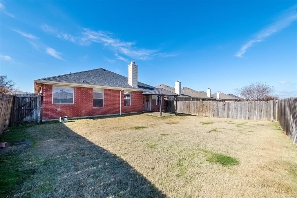 2716 Dawn Spring Drive Little Elm, TX 75068 - Photo 22 of 23 a view of a yard with a house