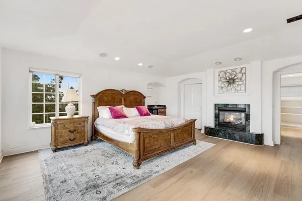 a bedroom with a large bed and a flat screen tv