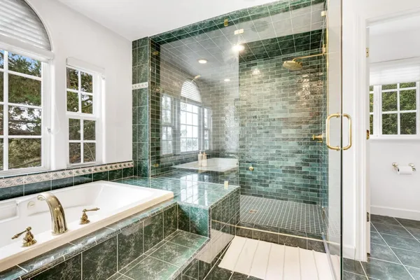 a bathroom with a granite countertop sink toilet a shower and a mirror