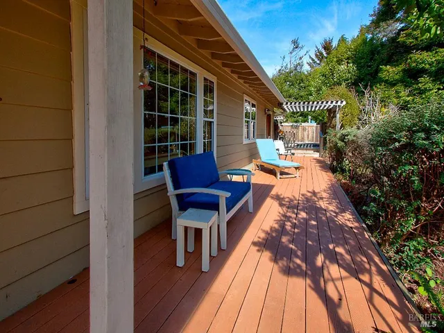 a view of a house with backyard sitting area and garden