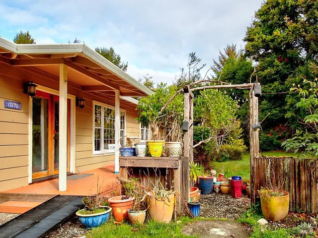 a front view of a house with a garden